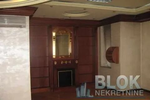Living room with decorative wood paneling, fireplace, and mirror. - image 3