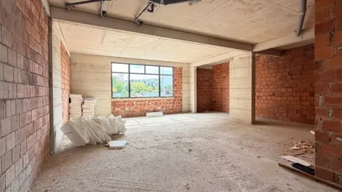 Unfinished bare-shell interior space with an open view through the window. - image 8
