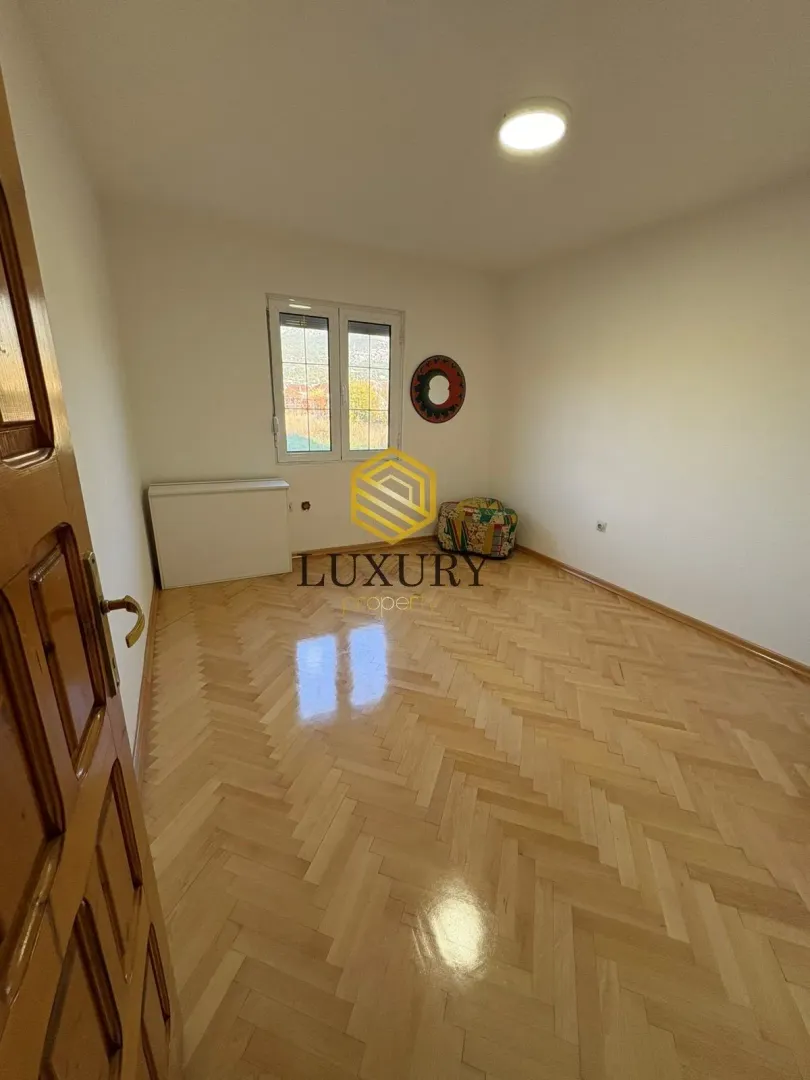 Empty room with parquet flooring and white walls.