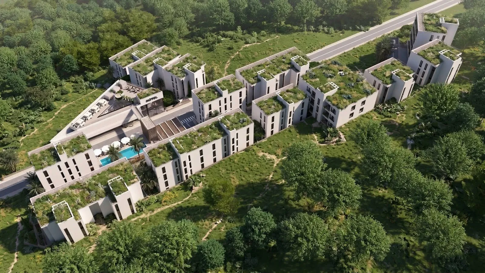 Pogled iz vazduha na moderne stambene objekte sa zelenim krovovima i bazenom.