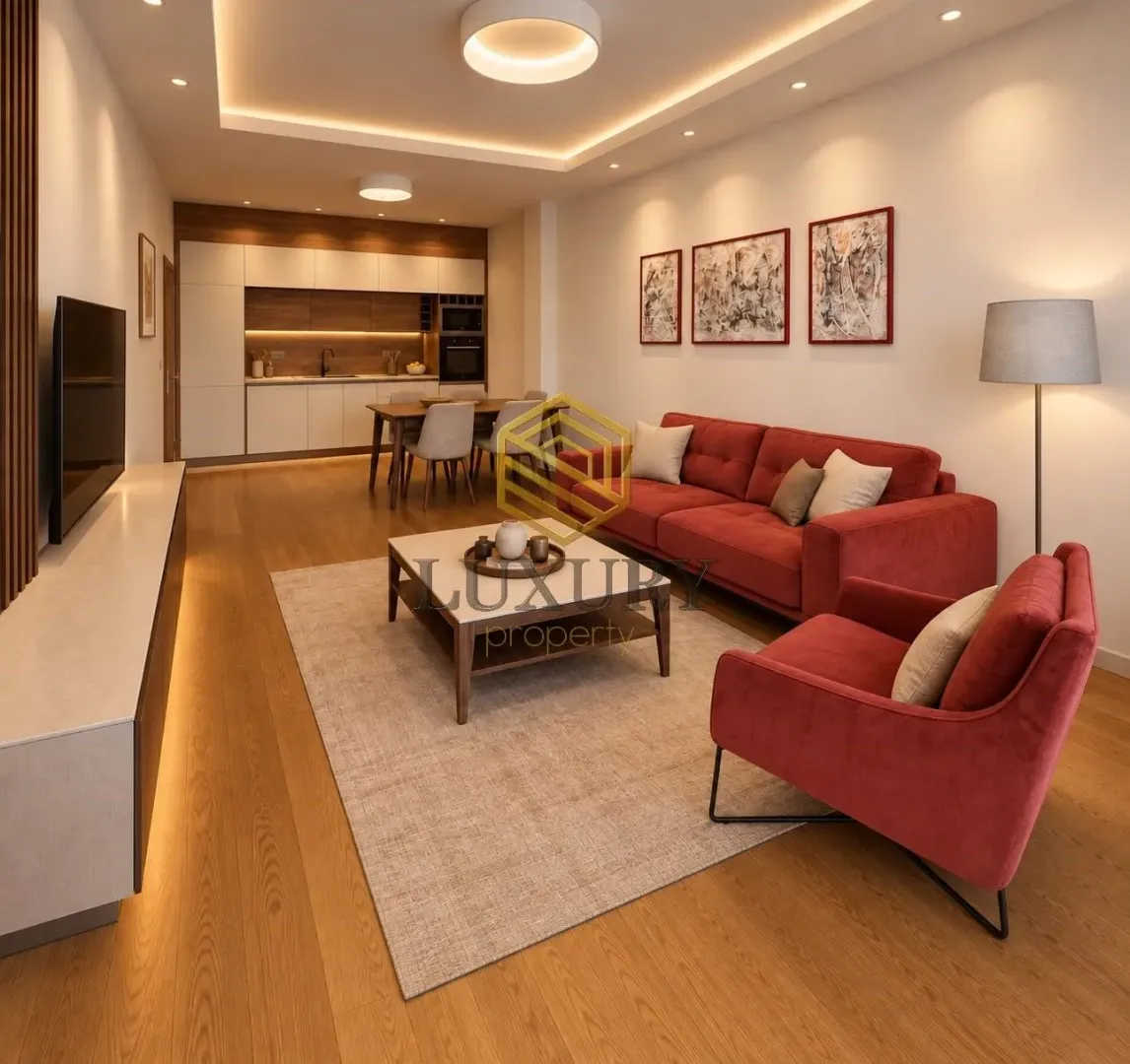 Modern living room connected to the dining area and kitchen.