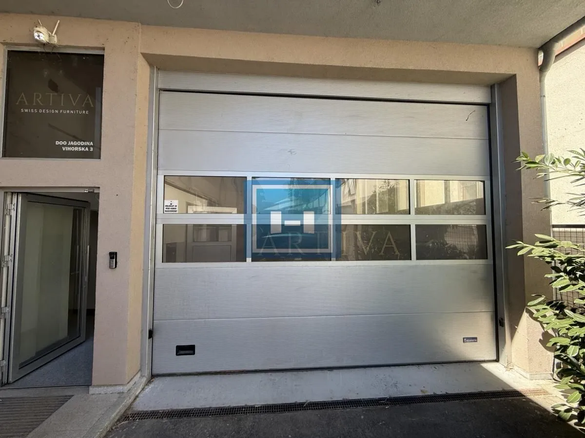 View of the entrance with roll-up doors and company signage.