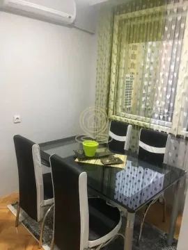 Trpezarijski sto sa crnim stolicama u svetloj prostoriji. - image 5
