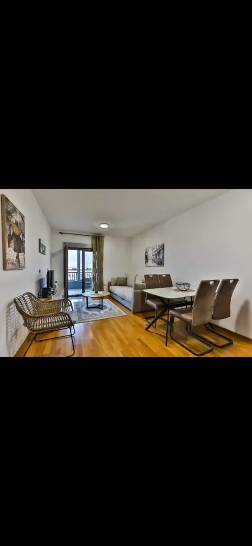 Living room with dining area and terrace access.