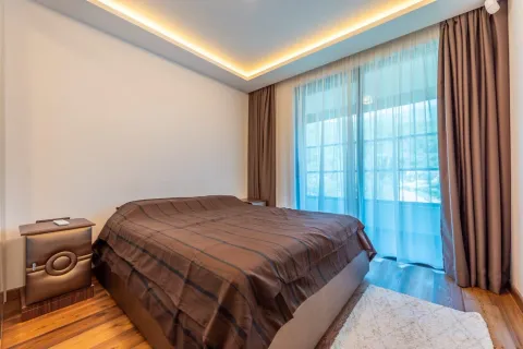 Bright bedroom with a double bed and decorative ceiling lighting. - image 19