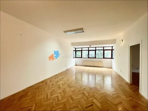 Empty spacious room with parquet flooring and large windows. - image 9