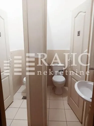 View of the restroom with tiles and sanitary fixtures.