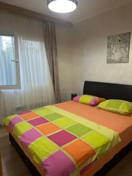 Furnished bedroom with a double bed and a window. - image 10