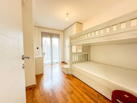 Children's bedroom with a bunk bed, wardrobe, and a desk. - image 12
