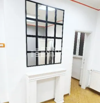 Living room with decorative fireplace and a large wall mirror. - image 2