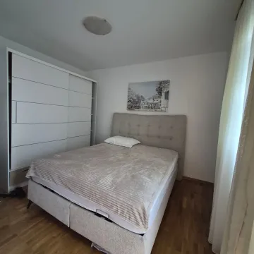A bedroom with a double bed, wardrobe, and hardwood flooring. - image 6