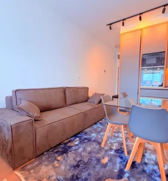 Living room with sofa and dining area. - image 7