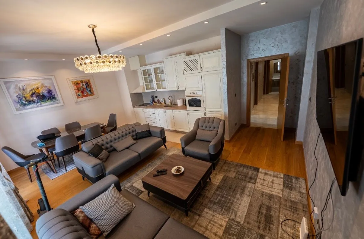 Modern and spacious living room connected to the dining area and kitchen.