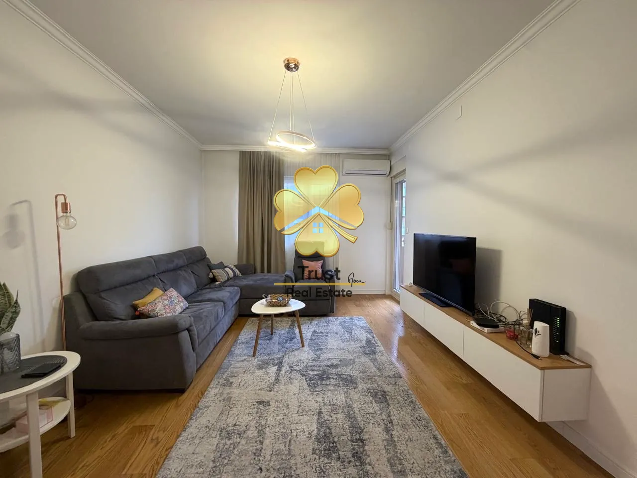 Furnished living room with a sofa and television.