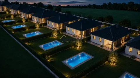 Noćni pogled iz vazduha na kompleks modernih kuća sa bazenima. - image 9