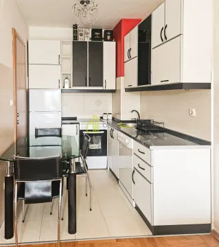Small kitchen with white cabinets, dining table and glass top. - image 7