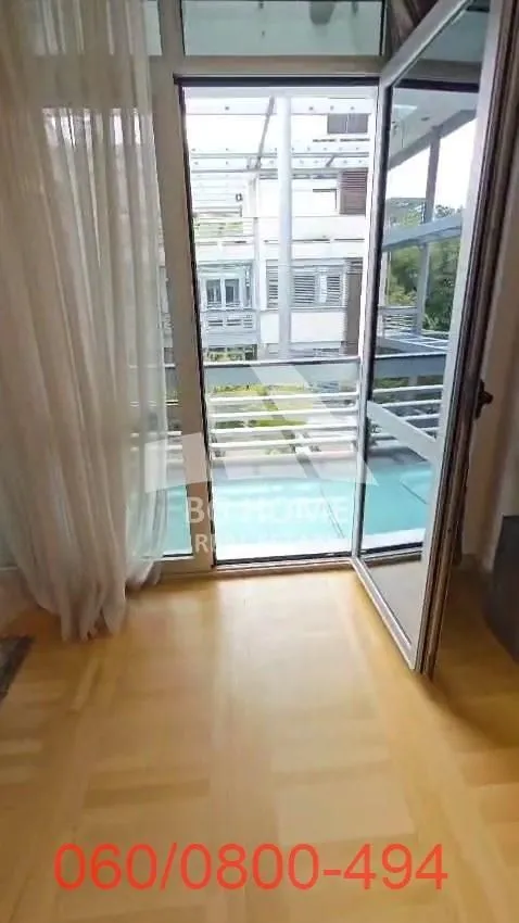 View through the open balcony door to the terrace and courtyard.