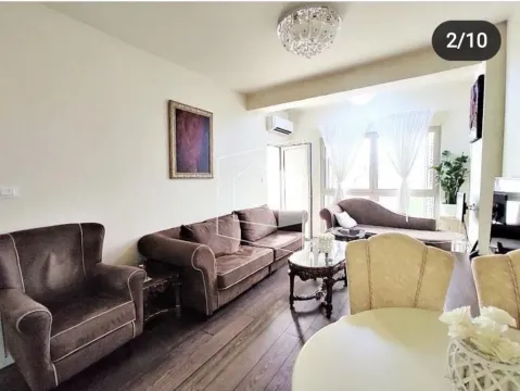 Living room with a sofa set and a dining table. - image 2