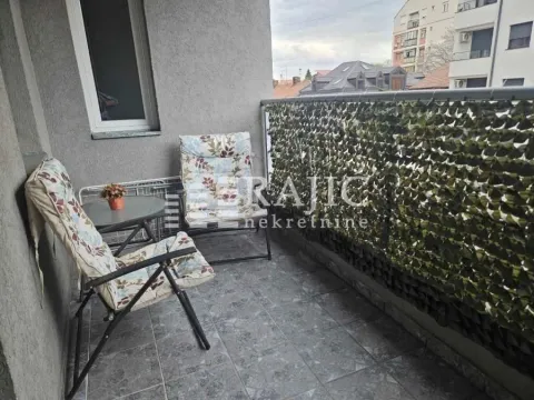 Small furnished balcony with chairs and a small table. - image 12