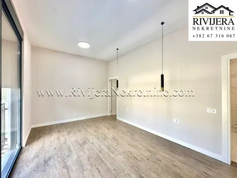 Empty room with wooden flooring, light walls, and pendant lamps. - image 5