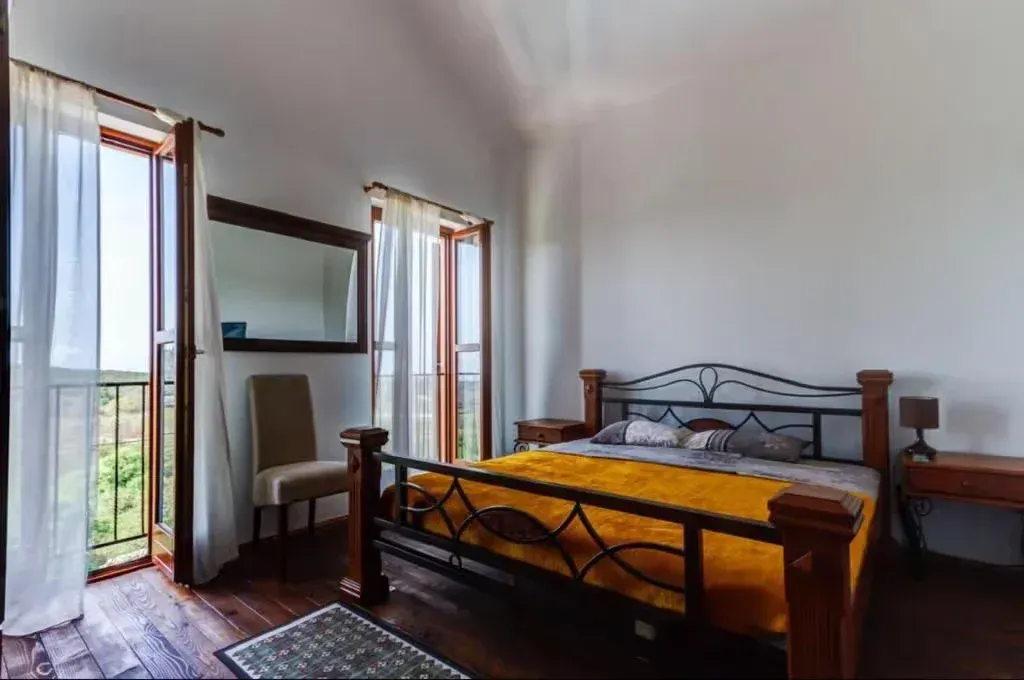 Spacious bedroom with a double bed and balcony access.