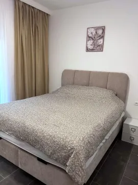 Bedroom with a double bed, bedside table, and curtains. - image 10