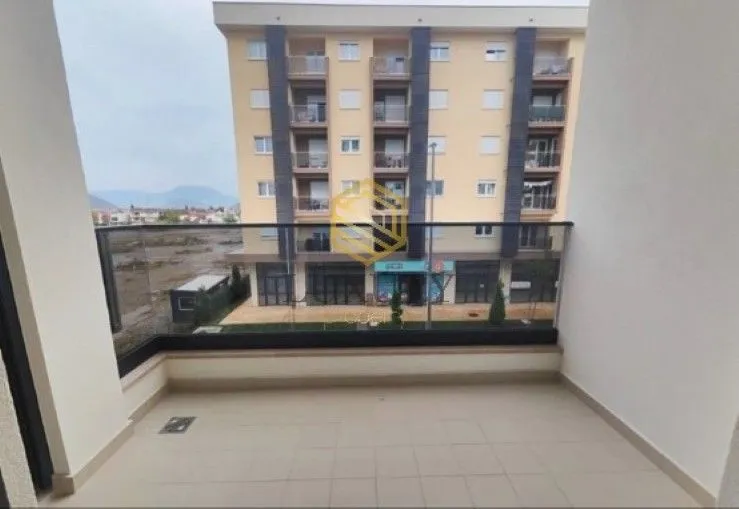 Spacious unfurnished balcony with a view of a residential building and surroundings.