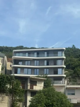 Exterior of a modern apartment building with terraces and glass railings. - image 11