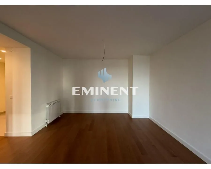 Empty room with hardwood flooring and white walls.