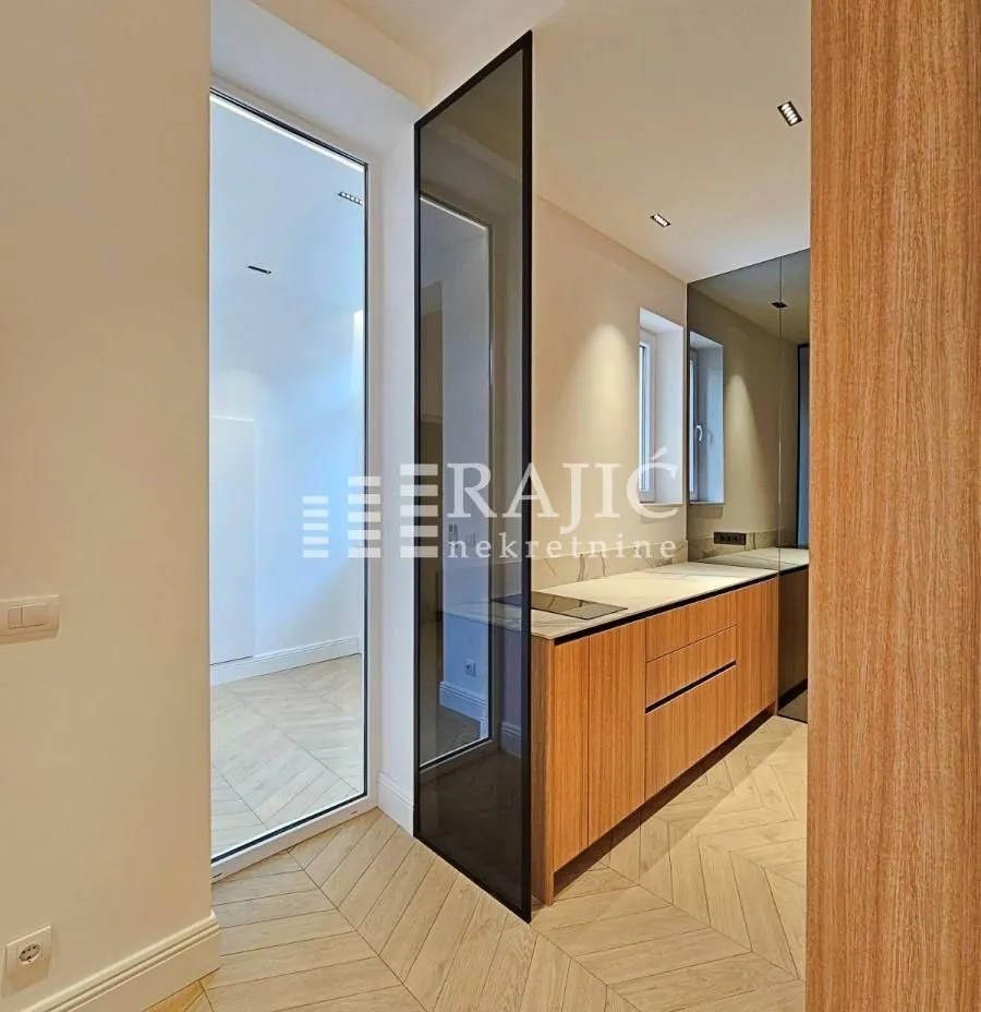 Modern kitchen with wooden cabinetry and built-in appliance.