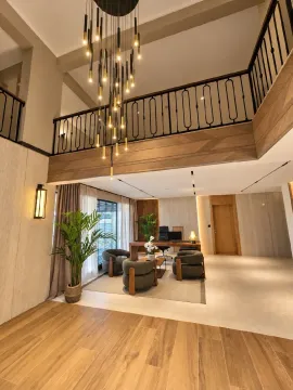 Spacious bright living room with a gallery and a modern chandelier. - image 2