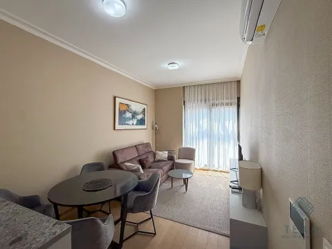 Living room with a sofa set, dining table, and access to the terrace. - image 3