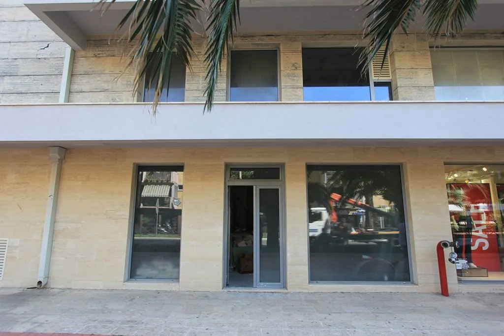 Exterior of a commercial space with large glass windows.