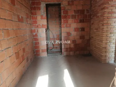 View of an unfinished room under construction with brick walls and a doorway. - image 18