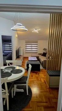 View of a modernly furnished living room with a dining area. - image 3