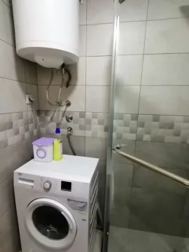 Bathroom with washing machine and shower. - image 18