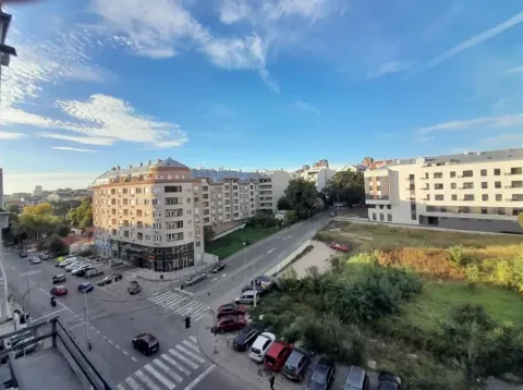 View from the window of surrounding buildings, street, and parking. - image 9