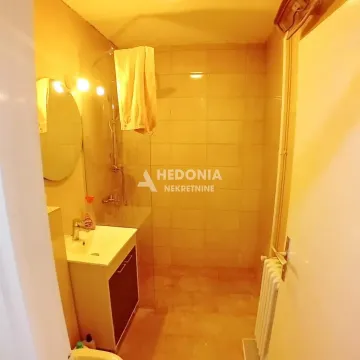 Smaller bathroom with a shower cabin and a washbasin. - image 5