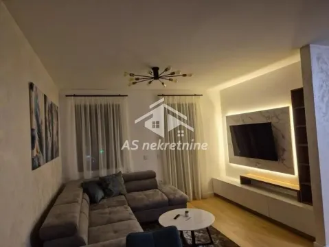 Living room with sofa, TV and modern lighting. - image 2