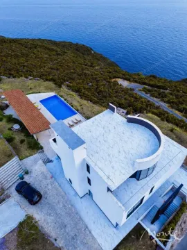Aerial view of a modern house with a swimming pool and sea view. - image 31