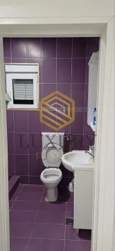 Small bathroom with purple tiles and sanitaryware. - image 4