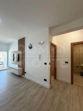 Living room with wooden wall panels and a TV. - image 3