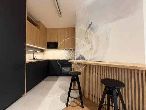 Modern kitchen with wooden elements and a bar counter with bar stools. - image 6