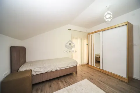 Bedroom with a bed and a large wardrobe. - image 5