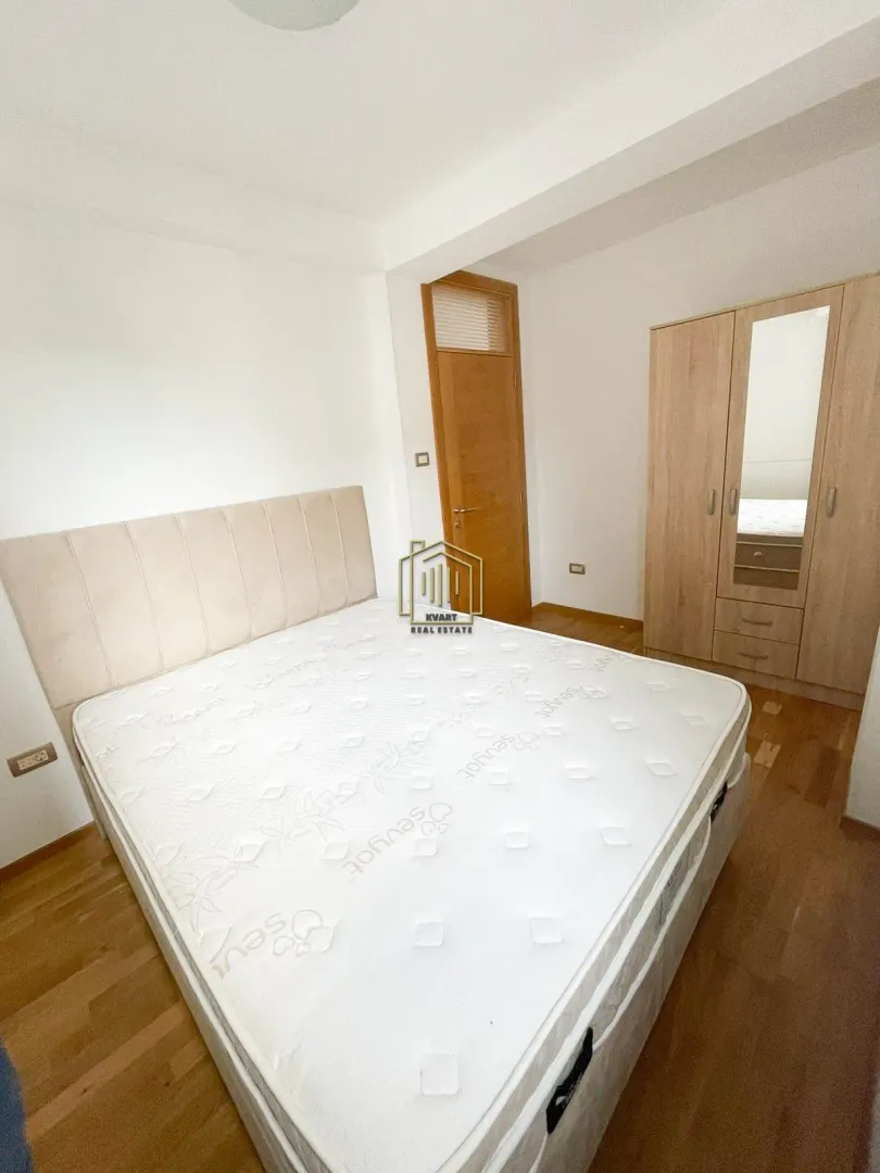 Bedroom with a double bed and wooden wardrobe.