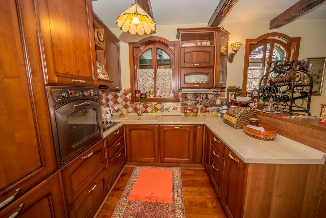 Traditional kitchen with wooden cabinets and a built-in oven.