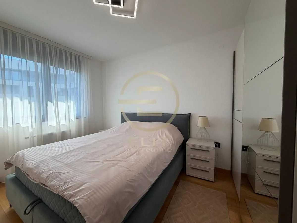 Bedroom with a double bed, bedside table, and built-in wardrobe.