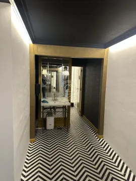 Small bathroom with a washbasin, mirror and black and white floor tiles. - image 18