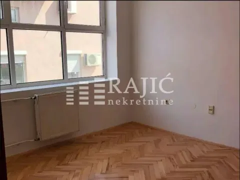 Empty room with parquet flooring and a window. - image 14