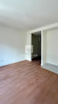Empty room with wooden flooring and white walls. - image 6